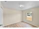Cozy bedroom with a bright window, neutral walls, and wood-look flooring at 288 Howard Blvd, Longwood, FL 32750