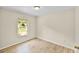 Well-lit bedroom with a large window, neutral walls, and wood-look flooring at 288 Howard Blvd, Longwood, FL 32750