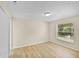 Bright bedroom with large window and closet, neutral walls and wood-look flooring at 288 Howard Blvd, Longwood, FL 32750