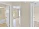 Hallway with doors leading to bathroom and bedrooms, neutral walls and light fixtures at 288 Howard Blvd, Longwood, FL 32750