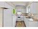 Efficient kitchen features white cabinetry, modern appliances, and wood-look flooring at 288 Howard Blvd, Longwood, FL 32750