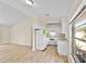 Bright kitchen area featuring modern white cabinets, new appliances, and wood look flooring at 288 Howard Blvd, Longwood, FL 32750