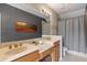This is a bathroom with double sinks, granite counters, a tiled floor, and a shower and tub combo at 316 Solaris Wharf St, Winter Springs, FL 32708
