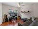 Bright bedroom with wood floors, ceiling fan, and a large window overlooking trees at 316 Solaris Wharf St, Winter Springs, FL 32708