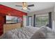 This is a bright bedroom with wood floors and a sliding door to a small balcony at 316 Solaris Wharf St, Winter Springs, FL 32708