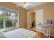 Bright bedroom with hardwood floors, a large window, and an adjacent home office setup at 316 Solaris Wharf St, Winter Springs, FL 32708
