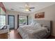 This bedroom has wood floors and a large window, a sliding door to a balcony at 316 Solaris Wharf St, Winter Springs, FL 32708
