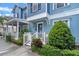 Lovely blue townhome with manicured front yard and inviting entrance, perfect for relaxing at 316 Solaris Wharf St, Winter Springs, FL 32708