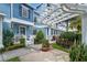 Beautiful blue townhome with pergola, well-maintained landscaping, and sidewalk at 316 Solaris Wharf St, Winter Springs, FL 32708