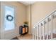 Inviting foyer with decorative front door and cabinet storage, leading to the staircase at 316 Solaris Wharf St, Winter Springs, FL 32708