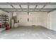 This is a two-car garage with white walls, a grey floor and lots of room for parking and storage at 316 Solaris Wharf St, Winter Springs, FL 32708