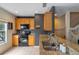 Cozy kitchen featuring granite countertops, stainless steel sink, and black appliances at 316 Solaris Wharf St, Winter Springs, FL 32708