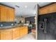 Updated kitchen with black appliances and granite countertops, open to the dining area at 316 Solaris Wharf St, Winter Springs, FL 32708