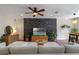 Living room featuring modern decor, a stone accent wall, and a wood entertainment center at 316 Solaris Wharf St, Winter Springs, FL 32708