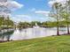 Picturesque pond with a fountain, surrounded by well-maintained green spaces and residential buildings at 316 Solaris Wharf St, Winter Springs, FL 32708