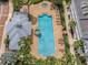Aerial shot of community pool, cabana, and jacuzzi, with lounge seating and nearby condo building at 316 Solaris Wharf St, Winter Springs, FL 32708