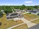 Bird's eye view of a home with solar panels and a neatly manicured front yard at 326 Woodland Trl, Lady Lake, FL 32159