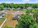An aerial view of a lovely home with solar panels in a friendly neighborhood, showcasing curb appeal at 326 Woodland Trl, Lady Lake, FL 32159