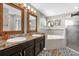 Bright bathroom featuring double vanity, soaking tub, glass enclosed shower and decorative rugs at 326 Woodland Trl, Lady Lake, FL 32159