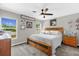 A bright bedroom offers natural light, a ceiling fan, and a comfortable bed with decorative pillows at 326 Woodland Trl, Lady Lake, FL 32159