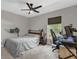 Bedroom with a ceiling fan, neutral walls, carpet, and a window with a view of the outdoors at 326 Woodland Trl, Lady Lake, FL 32159