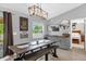 A cozy dining area showcases a wooden table, stylish lighting, and a bar with a beverage cooler at 326 Woodland Trl, Lady Lake, FL 32159