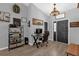 Welcoming entryway with chandelier, desk area, wood floors, and sophisticated decor at 326 Woodland Trl, Lady Lake, FL 32159