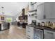 Modern kitchen with gray cabinets, beverage cooler, stainless appliances, and a view into the dining area at 326 Woodland Trl, Lady Lake, FL 32159