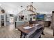 Spacious open-concept living area with a unique chandelier, dining table, and comfortable seating arrangement at 326 Woodland Trl, Lady Lake, FL 32159