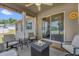 Covered patio features comfortable seating, an outdoor fire pit table and sliding glass doors at 326 Woodland Trl, Lady Lake, FL 32159