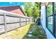 Fenced backyard with grass, stone walkway, and trees at 3328 Fox Ridge, Winter Haven, FL 33884