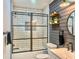 Stylish bathroom with a glass-enclosed shower, modern vanity, and decorative shelves at 3328 Fox Ridge, Winter Haven, FL 33884