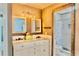 Bathroom featuring double vanities, granite countertops, and stylish lighting at 3328 Fox Ridge, Winter Haven, FL 33884