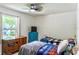 Cozy bedroom with two beds, a ceiling fan, and natural light at 3328 Fox Ridge, Winter Haven, FL 33884