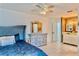 Primary bedroom features a ceiling fan, neutral walls, tile floors, and an ensuite bathroom at 3328 Fox Ridge, Winter Haven, FL 33884