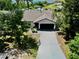 Aerial view of a single-story home with a long driveway leading to an attached two-car garage at 3328 Fox Ridge, Winter Haven, FL 33884