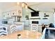 Open-concept living area with fireplace, TV, seamlessly connects to the dining area and kitchen at 3328 Fox Ridge, Winter Haven, FL 33884