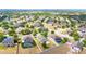 A scenic neighborhood aerial view with tree-lined streets and well-maintained homes with lush landscaping at 337 Giovani Blvd, Clermont, FL 34715
