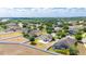 A neighborhood aerial view shows well-spaced homes with lush landscaping, pools, and cul-de-sac streets at 337 Giovani Blvd, Clermont, FL 34715