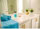 Bright bathroom featuring white marble countertop, gold hardware, and stylish decor at 337 Giovani Blvd, Clermont, FL 34715