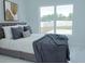 Modern bedroom with large window, plush bedding, and stylish decor at 337 Giovani Blvd, Clermont, FL 34715