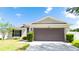 Charming single-story home with a well-maintained lawn, lush greenery, and a spacious two-car garage at 337 Giovani Blvd, Clermont, FL 34715