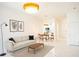 Bright, open-concept living room with modern furniture, statement lighting, and decor at 337 Giovani Blvd, Clermont, FL 34715