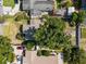 Overhead shot of a house, backyard with mature trees, an outdoor fire pit, and a privacy fence at 3601 Midiron Dr, Winter Park, FL 32789
