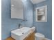 Stylish bathroom featuring a modern vessel sink, sleek faucet, and textured blue walls at 3601 Midiron Dr, Winter Park, FL 32789