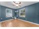 Inviting bedroom with hardwood floors, natural light, and a ceiling fan for added comfort at 3601 Midiron Dr, Winter Park, FL 32789