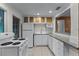 Functional kitchen with white appliances, white cabinetry, and a view to the living area at 3601 Midiron Dr, Winter Park, FL 32789