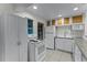 Well-lit kitchen features white cabinets, appliances, neutral countertops and tile flooring at 3601 Midiron Dr, Winter Park, FL 32789