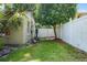 Fenced side yard with a grill, utility connections, and mature landscaping at 3601 Midiron Dr, Winter Park, FL 32789