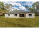 A spacious backyard and patio with plenty of green grass and lush trees at 3777 Sw 130Th Loop, Ocala, FL 34473